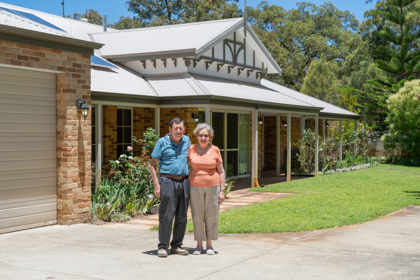 Street view photo of loyal Plunkett Home clients Eric and Leonie standing outside of their new federation-style home.