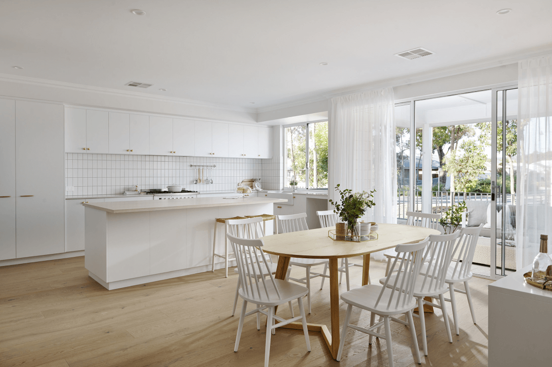A contemporary kitchen and dining space with an open-floor layout sitting inside a federation-style home designed by Plunkett Homes in Perth.